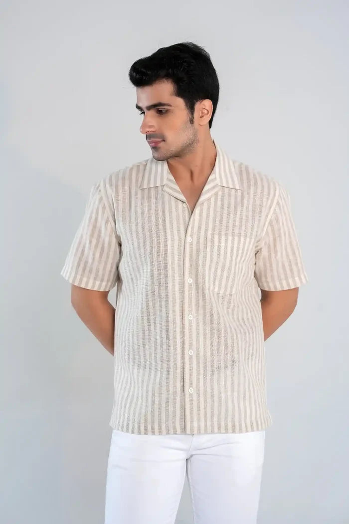 Model wearing beige striped linen blend oversized summer shirt with button-down front