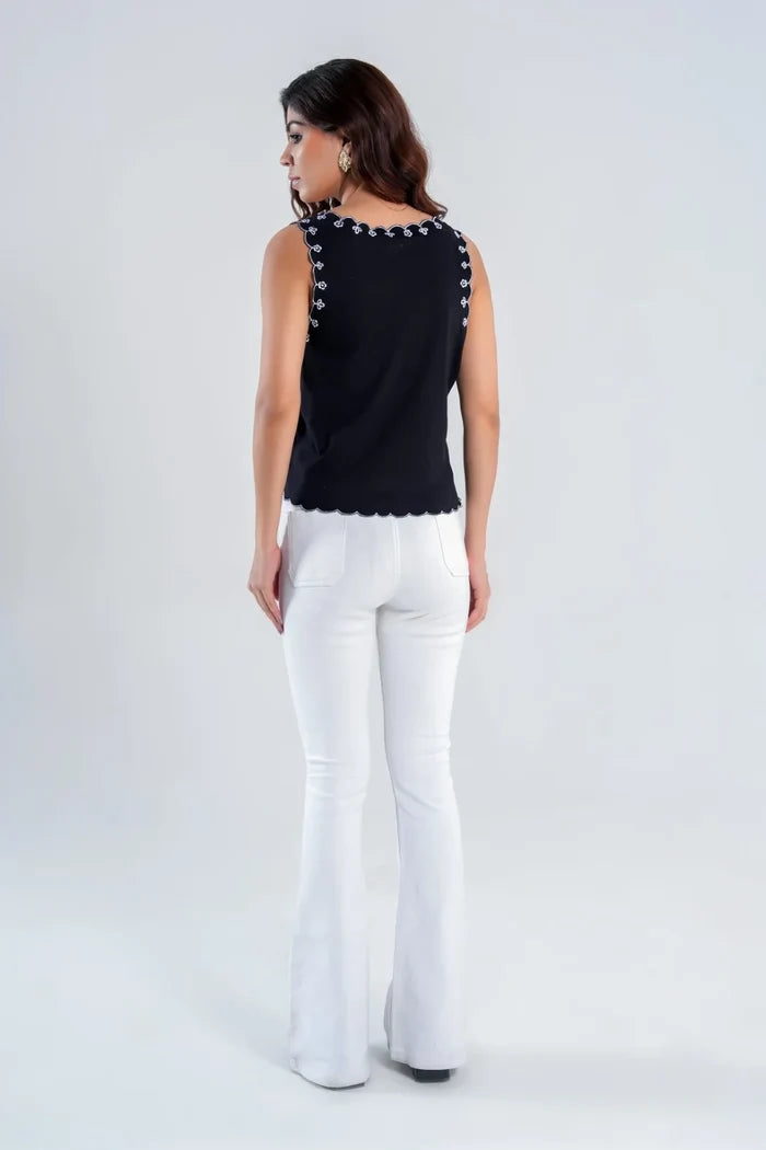 Back view of black scallop embroidered hip-length sleeveless V-neck top with scallop hem