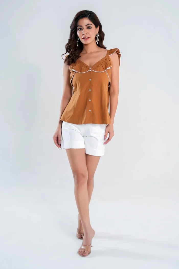 Model in brown cotton cottagecore top styled with white shorts