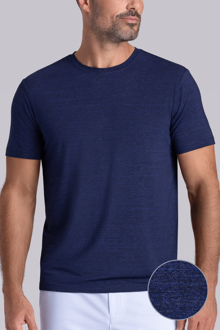 Model wearing the Fundamental Navy Heather Icy Bamboo® short sleeve crewneck, styled with white shorts.