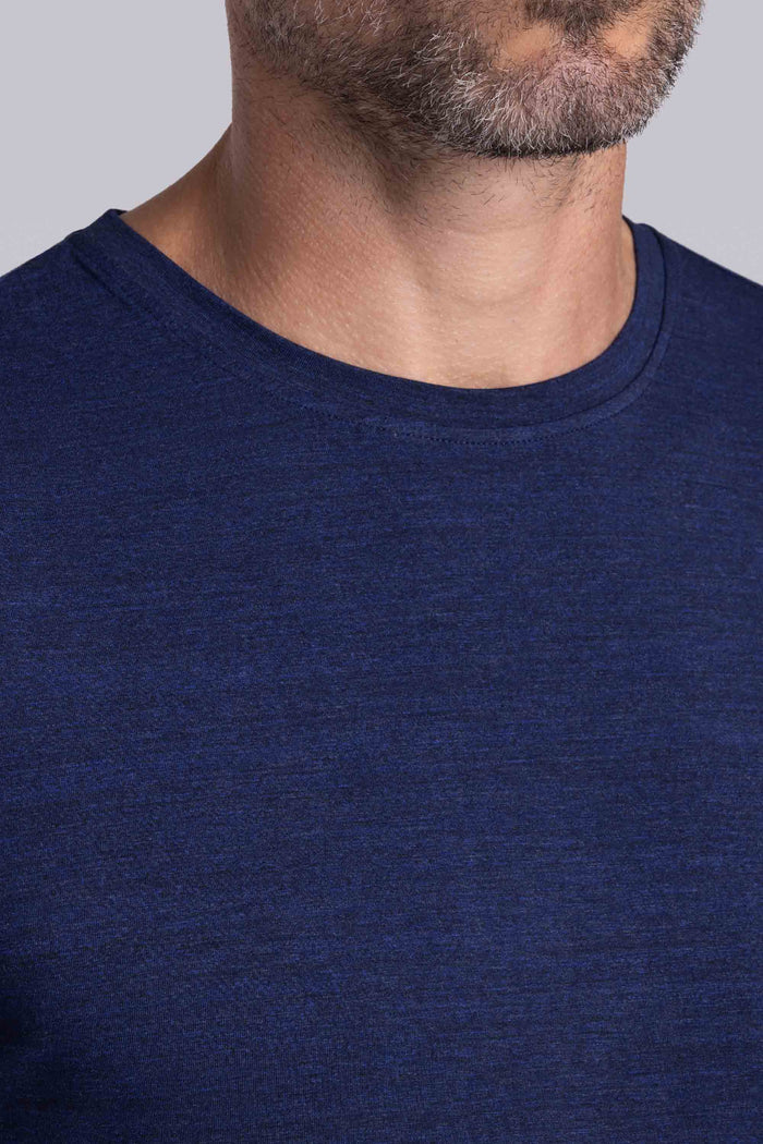 Model wearing the Fundamental Navy Heather Icy Bamboo® short sleeve crewneck, styled with white shorts.