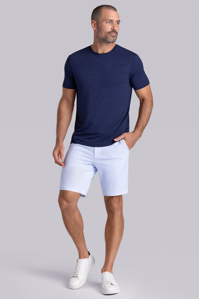 Model wearing the Fundamental Navy Heather Icy Bamboo® short sleeve crewneck, styled with white shorts.