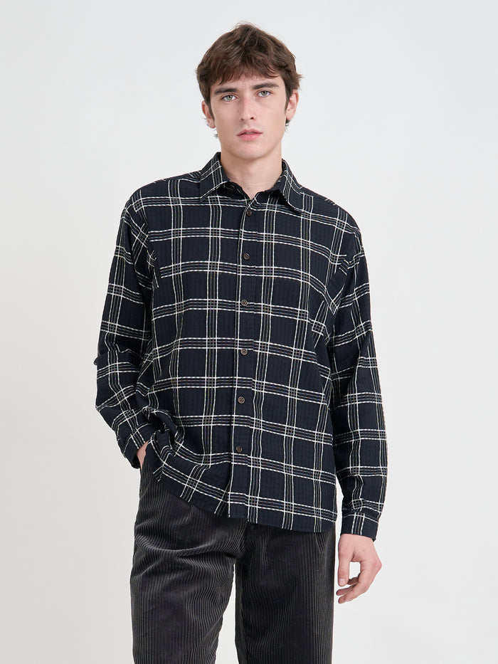 Close up shot of model wearing Oliver Spencer Loose Fitting Garrison Long Sleeve Shirt in Connell Black