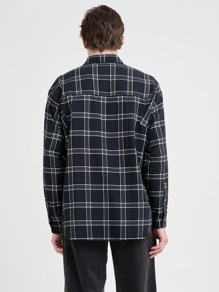 Back shot of model wearing Oliver Spencer Loose Fitting Garrison Long Sleeve Shirt in Connell Black