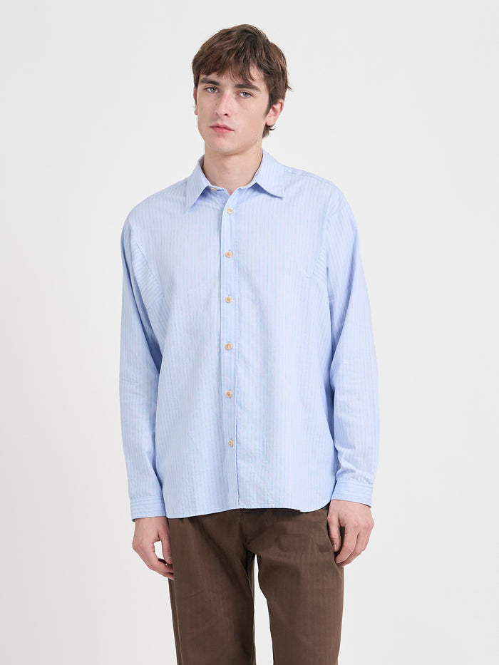 Close up shot of model wearing Oliver Spencer Loose Fitting Garrison Long Sleeve Shirt in Faber Blue