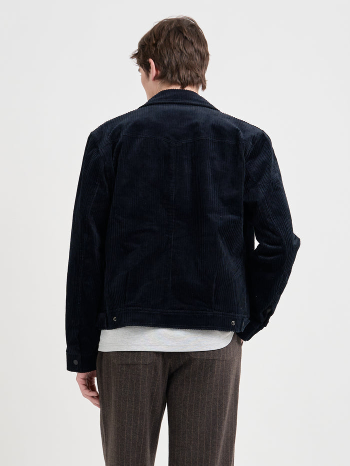 Close up back shot of model wearing Oliver Spencer Men's Midnight Navy Cotton Corduroy Trucker Jacket Flat Shot