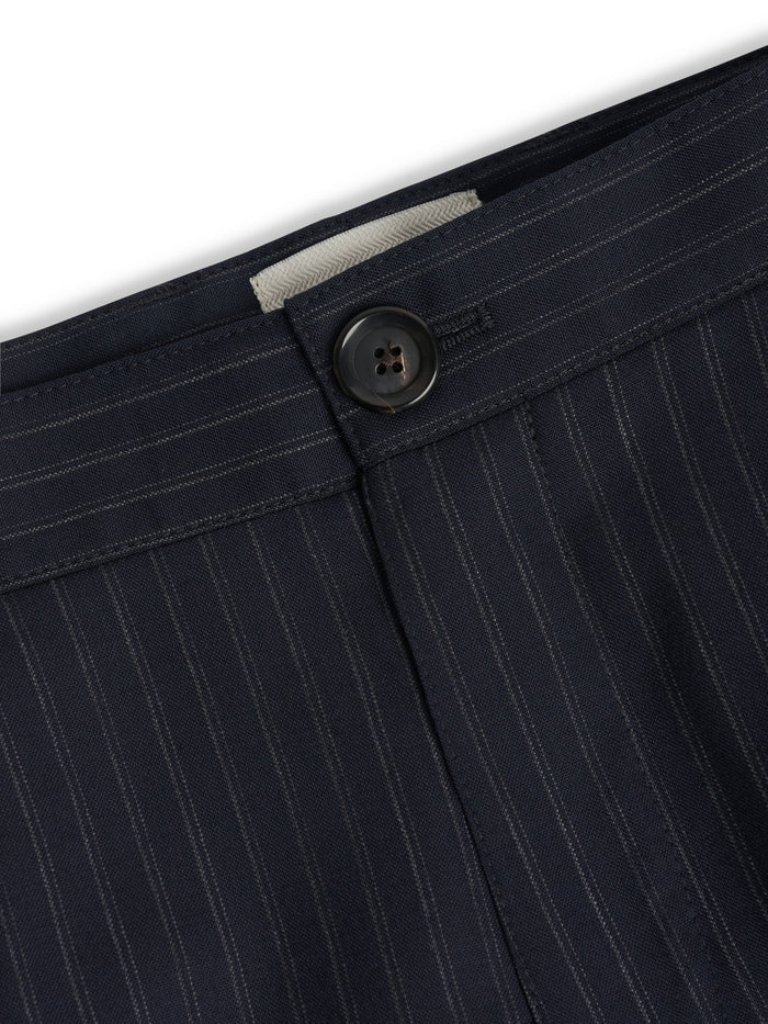 Orsman trousers in navy pinstripe wool showing single pleat and waistband detail