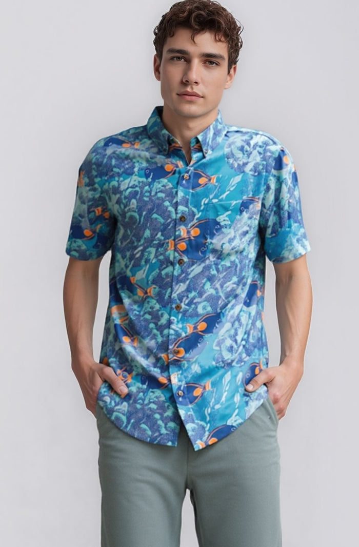 Man wearing a blue David Shepard patterned aloha shirt against a white background