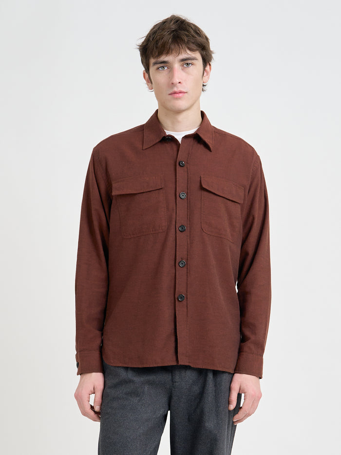 Close up shot of model wearing an Oliver Spencer Penryn Overshirt in Banfield Rust