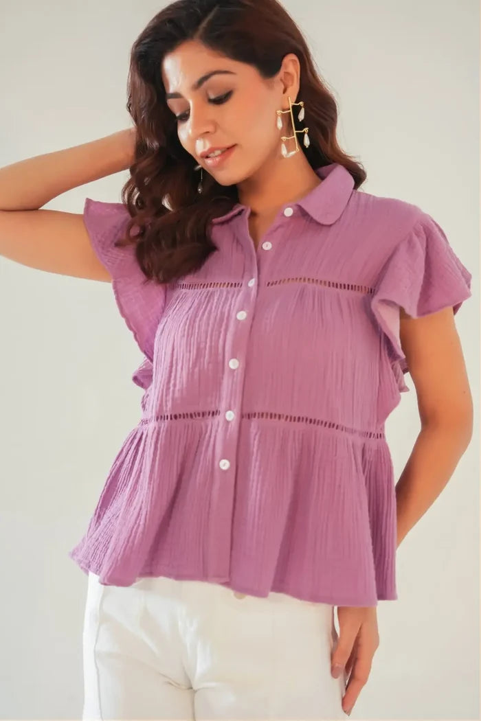 Close-up of lace insert and button details on purple cotton ruffle sleeve top