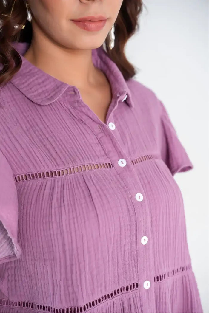 Close-up of lace insert and button details on purple cotton ruffle sleeve top