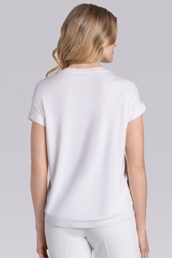 Model wearing Savanna Whisper White Icy Bamboo® crew neck short sleeve t-shirt, styled with white pants.