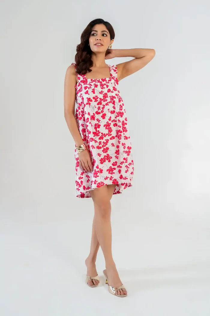 Model wearing a women’s white cottagecore sundress with bold red floral print and ruffle straps – casual cottagecore outfit for summer.