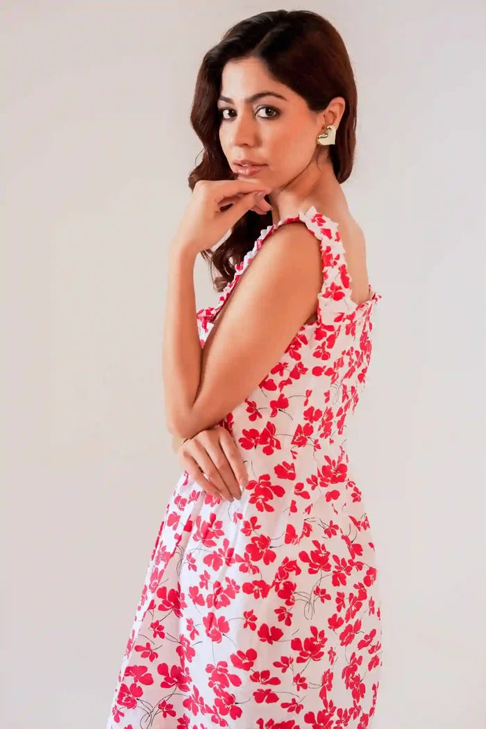 Side view of women’s white cotton sundress with red floral print and ruffle straps, showing airy flowy silhouette.