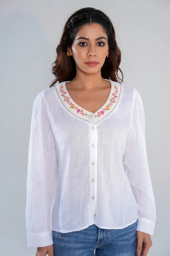 Front view of women’s white cotton long sleeve shirt with floral embroidered neckline