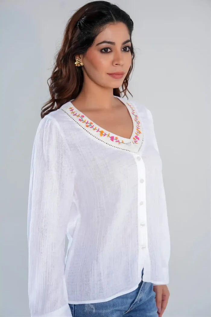 Side view of women’s white cotton embroidered V-neck button-down shirt