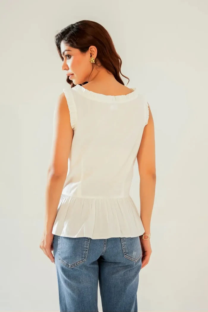 Back view of white sleeveless cotton peplum top with frill trim and gathered hem – cottagecore blouse in breathable cotton