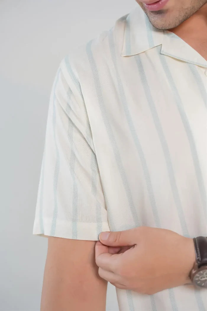 Close-up of sleeve and fabric texture on white and blue striped 100% cotton shirt for men