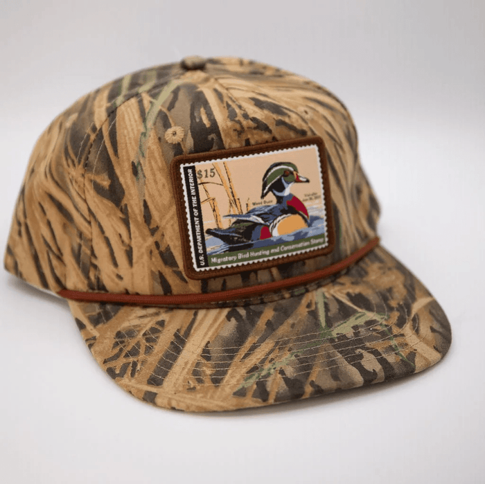 Woodley Co Duck Stamp Hat Wood Duck 12’-13’ Woodley Co Mossy Oak Shadowgrass Rope Headwear Rivers and Glen Trading Co
